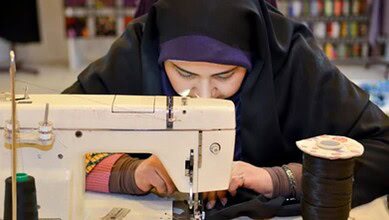 Sewing enthusiast working on a tailored garment using a vintage sewing machine. Crafting, fashion design, and tailoring skills showcased.