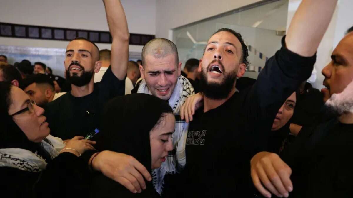Freed Palestinians are greeted by their families in Ramallah [Mussa Qawasma/Reuters]