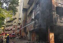 Firefighters try to douse a fire that broke out at Brahmaputra Apartments, in New Delhi on Saturday. The apartment complex houses residences of several Lok Sabha and Rajya Sabha MPs. (PTI Photo/Karma Bhutia)