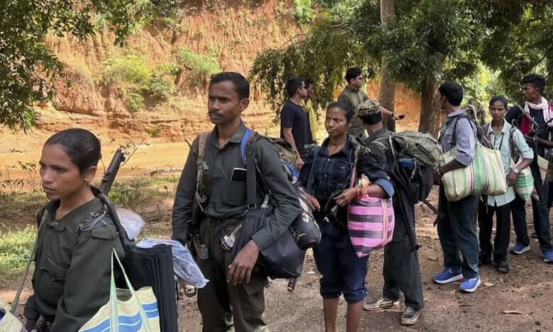 Maoist cadres surrender with weapons before the authorities, in Kanker district, Chhattisgarh, on October 26, 2025. (PTI Photo)