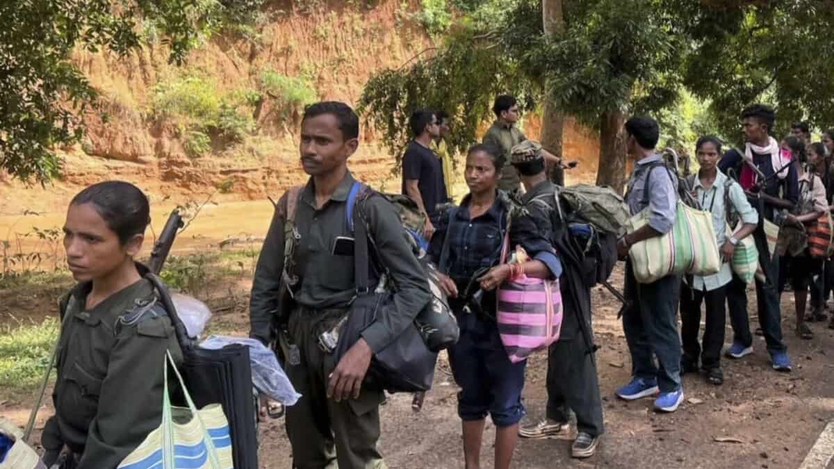 Maoist cadres surrender with weapons before the authorities, in Kanker district, Chhattisgarh, on October 26, 2025. (PTI Photo)