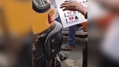 Members of Hindutva organisation stick "I Love Mahadev" on vehicles