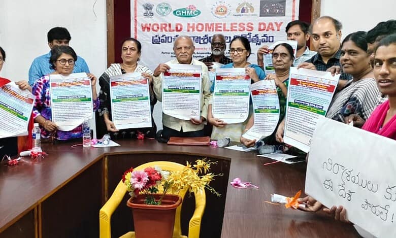 The image shows social activists releasing a poster on the occasion of World Homeless Day meeting held at Sundarayya Vignana Kendram on Friday, October 9, 2025.