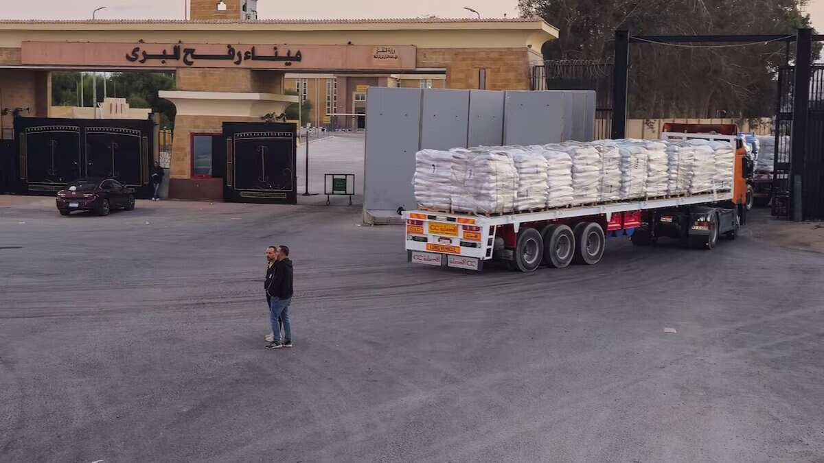 Trucks carrying humanitarian aid enter Gaza through the Rafah crossing on the Egypt side during a ceasefire between Israel and Hamas.