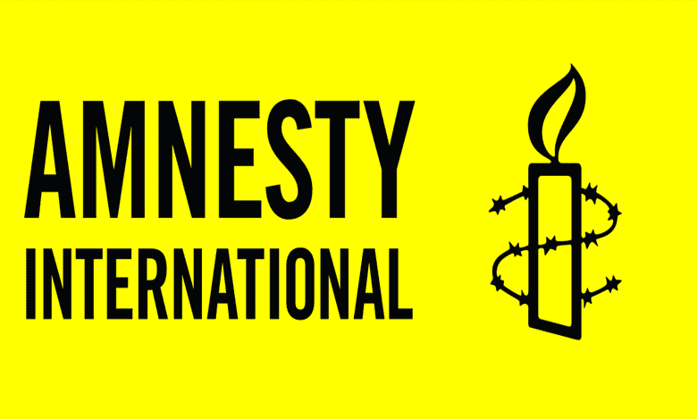 Logo of Amnesty International featuring a candle wrapped in barbed wire on a yellow background.