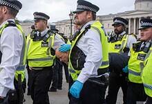 British police officers escort detained protesters during a pro-Palestinian demonstration in Trafalgar Square, London.