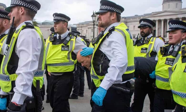 British police officers escort detained protesters during a pro-Palestinian demonstration in Trafalgar Square, London.
