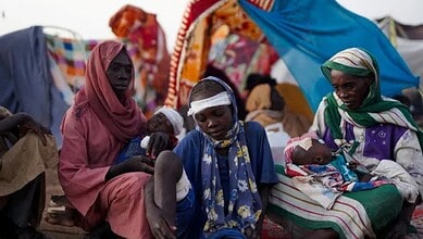Displaced Sudanese families, including injured children, rest at a camp in Tawila, North Darfur, after fleeing El-Fasher..