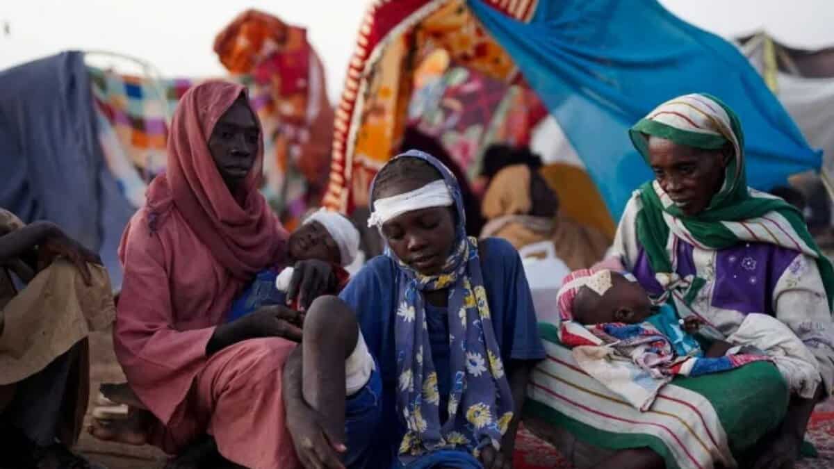 Displaced Sudanese families, including injured children, rest at a camp in Tawila, North Darfur, after fleeing El-Fasher..