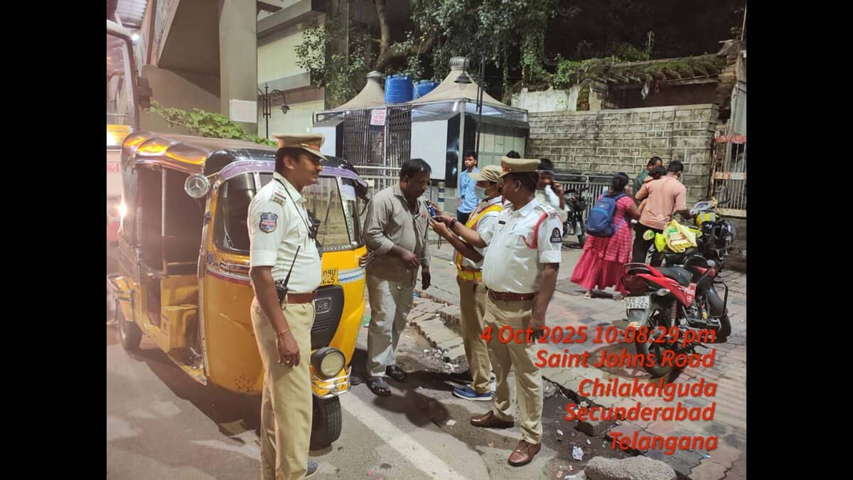 An auto driver is made to blow in a breathalyser during a drunk driving check in Hyderabad