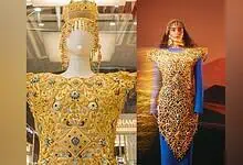 The “Dubai Dress,” crafted by Al Romaizan Gold and Jewellery, an intricately engraved 21-karat gold gown adorned with gemstones and a matching headdress.