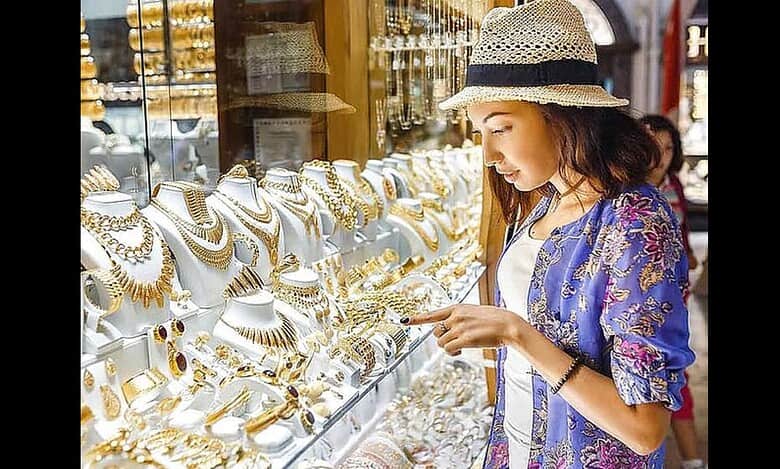 A woman examines gold jewellery on display at a shop in Dubai’s Gold Souk.