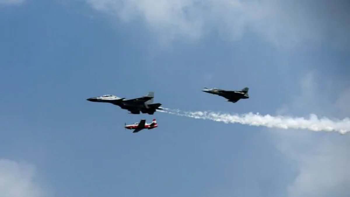 Indian Air Force fighter jets performing in formation during a flight demonstration.