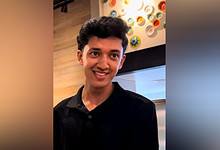 Vaishnav Krishnakumar, an 18-year-old Indian student in Dubai, smiling in a casual indoor setting.