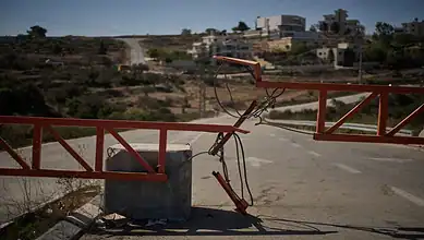 A metal gate blocks a road leading into a West Bank village as part of Israel’s increased barriers during the Gaza war.