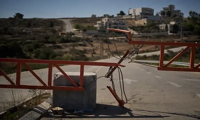 A metal gate blocks a road leading into a West Bank village as part of Israel’s increased barriers during the Gaza war.