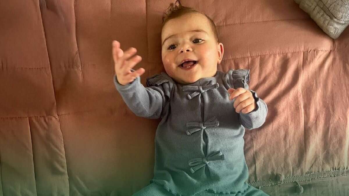 Palestinian baby Mira Suhaib Akkad smiling after successful heart surgery in Saudi Arabia.