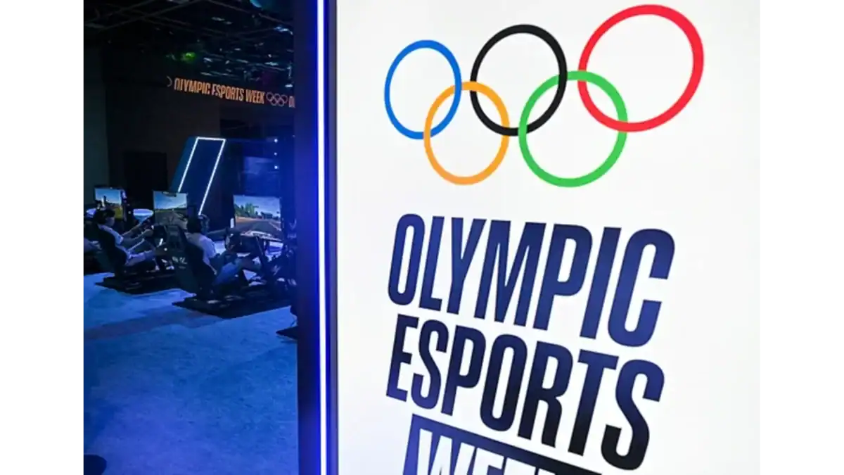Olympic Esports Week logo displayed beside gaming stations at an event.
