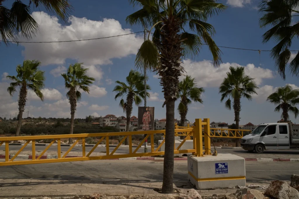 A Palestinian vehicle passes a yellow gate set up by Israeli authorities at the entrance of Turmus Ayya in the occupied West Bank.