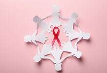 paper women and pink rbbon for cancer awareness