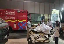 Indian embassy officials and medical staff assist a paralysed Hyderabad man being transferred on a stretcher between ambulances at Riyadh airport, Saudi Arabia.