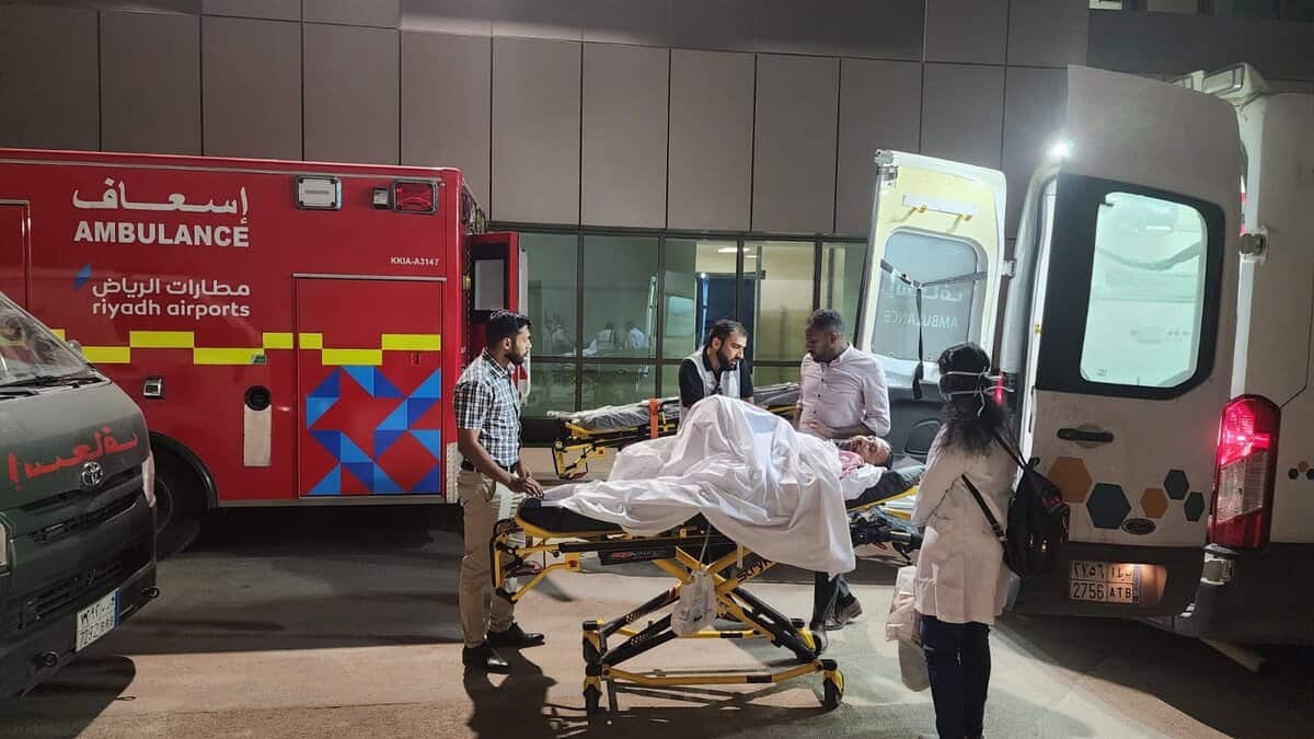 Indian embassy officials and medical staff assist a paralysed Hyderabad man being transferred on a stretcher between ambulances at Riyadh airport, Saudi Arabia.
