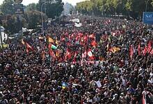Large crowd waves flags during a pro-Palestinian protest in Bologna, Italy.