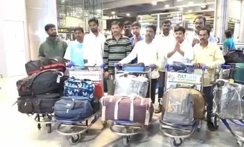 Twelve Telangana migrant workers stranded in Jordan arrive safely at Hyderabad airport with their luggage after repatriation.