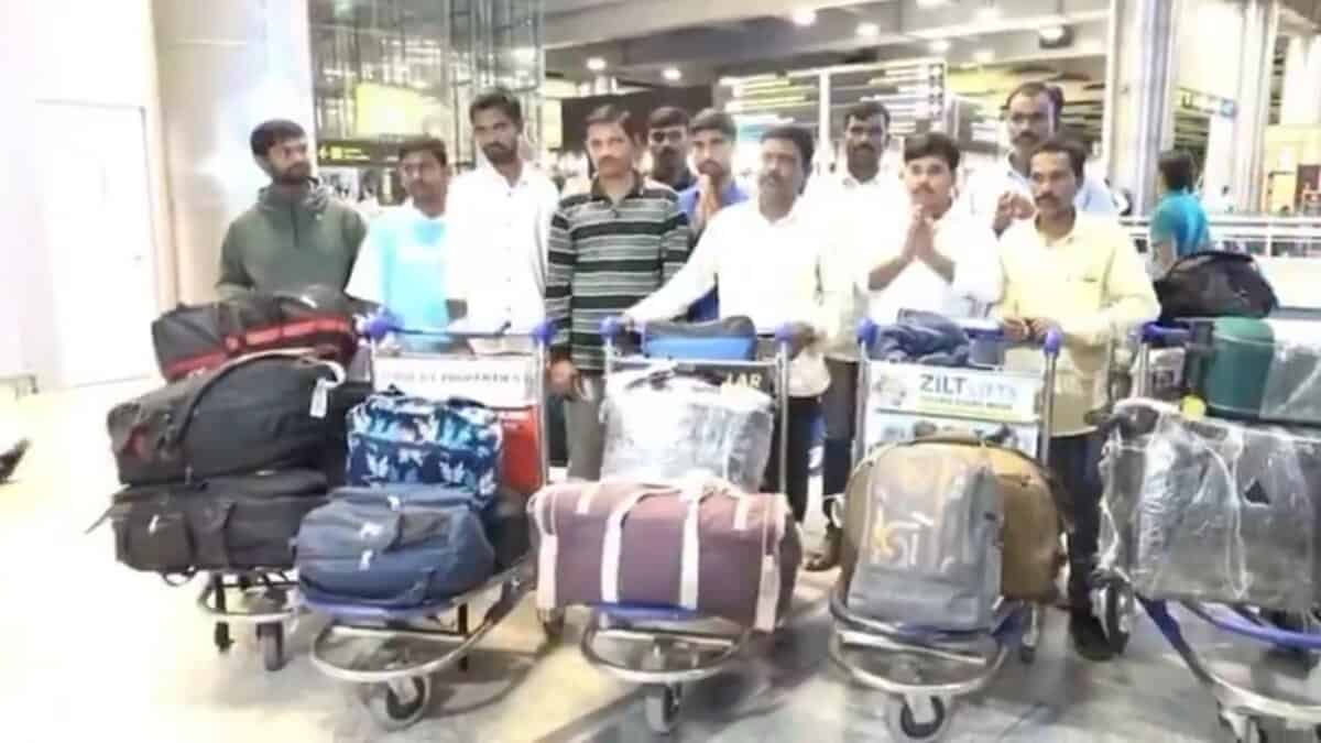 Twelve Telangana migrant workers stranded in Jordan arrive safely at Hyderabad airport with their luggage after repatriation.