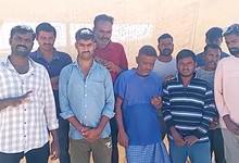 A group of stranded Telangana migrant workers in Jordan standing together under the sun, appealing for help to return home.