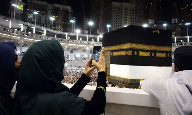 Representative image: A woman photographs the Kaaba at the Grand Mosque in Makkah during Umrah.