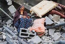 A Palestinian woman weeps outside her destroyed home after an Israeli air strike in central Gaza.