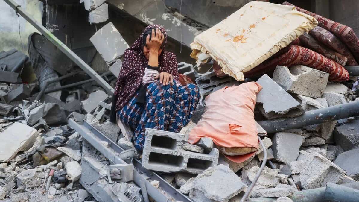 A Palestinian woman weeps outside her destroyed home after an Israeli air strike in central Gaza.