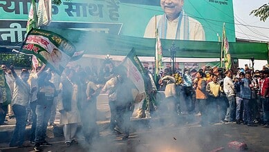 BJP supporters celebrate their alliance's lead in the initial results of the Bihar Assembly polls, in Patna,