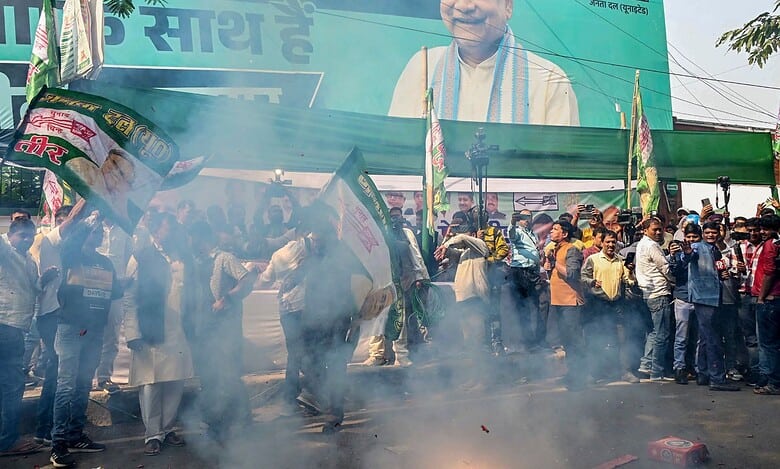 BJP supporters celebrate their alliance's lead in the initial results of the Bihar Assembly polls, in Patna,