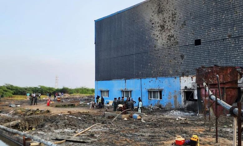 Defence personnel inspect the site of the aircraft crash near Thiruporur