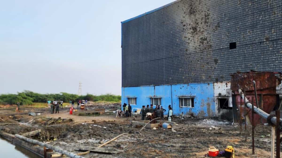 Defence personnel inspect the site of the aircraft crash near Thiruporur
