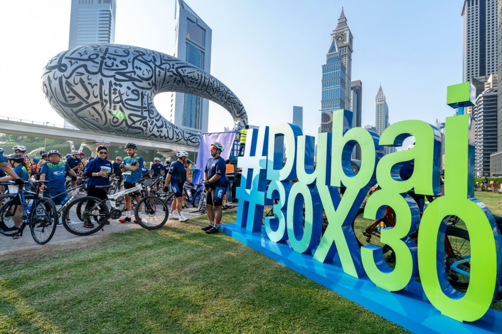 Cyclists gather near the Museum of the Future in Dubai for the 30x30 fitness challenge.