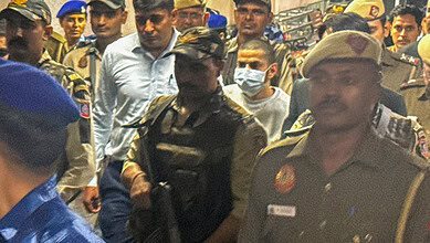 Gangster Anmol Bishnoi, in mask, while being produced in the Patiala House Court, in New Delhi.