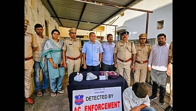 Telangana excise department officials display the seized hash oil