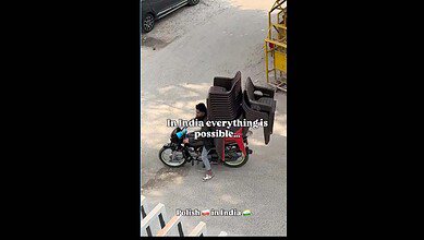 Man carries chairs on bike in India