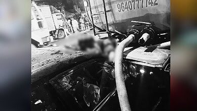 Image shows an accident with the victim stuck between a car and a water tanker