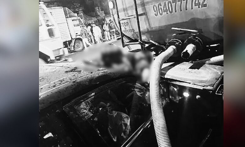 Image shows an accident with the victim stuck between a car and a water tanker