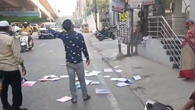 Image shows books fallen on a road in Hyderabad