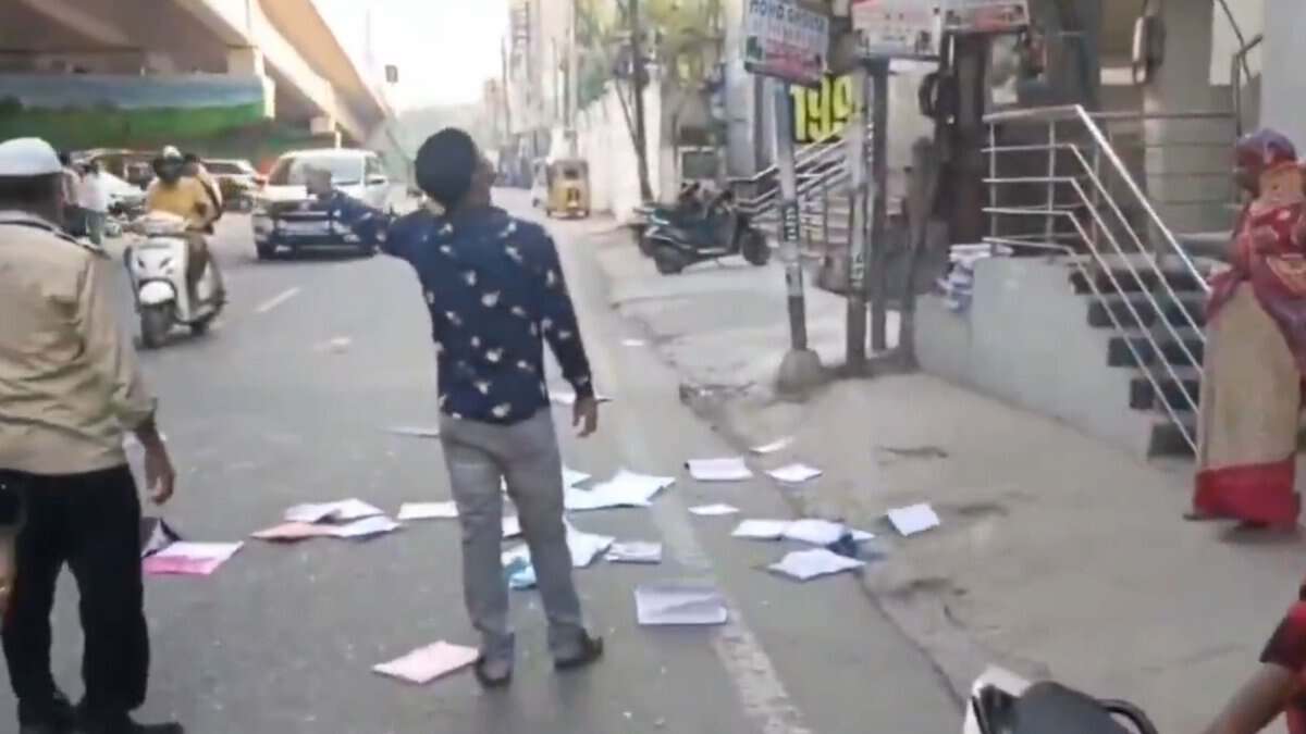 Image shows books fallen on a road in Hyderabad