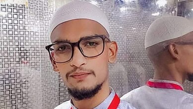 Mohammed Abdul Shoeb wearing glasses and a white prayer cap.
