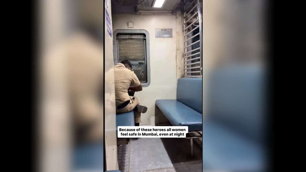 Mumbai policeman keeps watch over a lone woman on a local train.