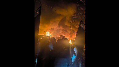 People gather after a blast at a police station in Jammu Kashmir