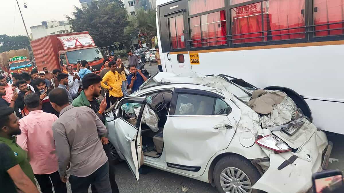 People stand near mangled remains of a car after an accident on the Mumbai-Bengaluru Highway, in Pune- PTI