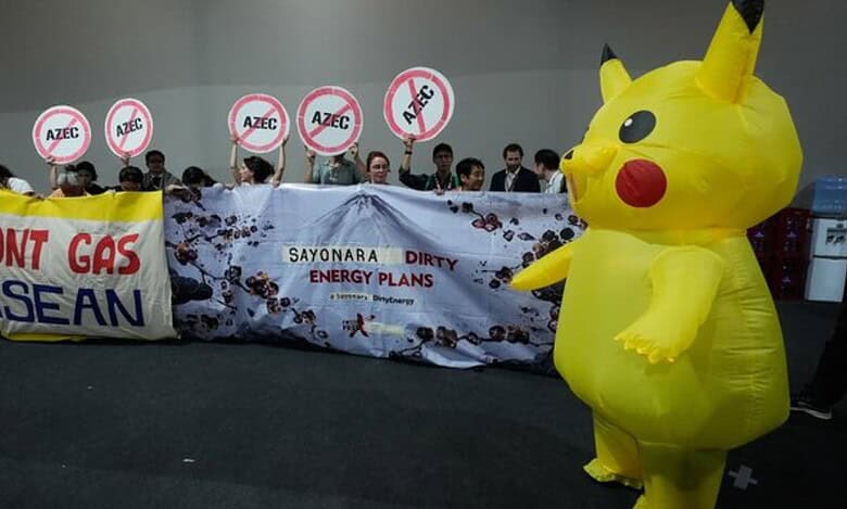Activists, and one dressed in a Pikachu costume, protest Japan's financing of coal and natural gas projects during the COP30 U.N. Climate Summit, Friday, Nov. 14, 2025, in Belem, Brazil. (AP Photo)